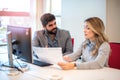 Business woman showing important business document to her male colleague at a meeting in office. Royalty Free Stock Photo