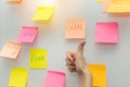 Business woman showing thumbs up with colored sheets sticky note paper on white board background Royalty Free Stock Photo