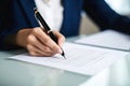 Business woman signing contract close up. Businesswoman lawyer looks over agreement. Royalty Free Stock Photo