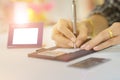 Business woman signing credit card slip close-up slightly blurred