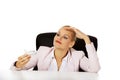 Business woman sitting behind the desk and holding a toy plane Royalty Free Stock Photo