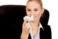 Business woman sitting behind the desk and holding a toy plane Royalty Free Stock Photo