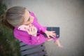 Business woman sitting on a bench in the street