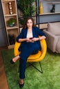 Business woman sitting in a chair in a chic office Royalty Free Stock Photo