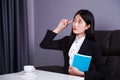 Business woman sitting at the desk and thinking to her work Royalty Free Stock Photo
