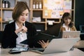 Business woman sitting on desk using laptop. Portrait of busy secretary typing in working environment. Happy young businesswoman Royalty Free Stock Photo