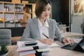 Business woman sitting on desk using laptop. Portrait of busy secretary typing in working environment. Happy young businesswoman Royalty Free Stock Photo