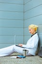 Business woman sitting on floor and using laptop Royalty Free Stock Photo