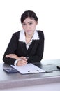 Business woman sitting on her desk holding a pen working with do Royalty Free Stock Photo