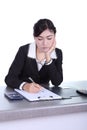 Business woman sitting on her desk holding a pen working with do Royalty Free Stock Photo