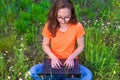 Business woman sitting with laptop in the park, free space. Royalty Free Stock Photo