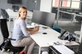 Business woman sitting in office. Woman having pause in work. Lo