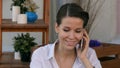 Business woman sitting relaxed at outdoor cafe talking using her cell phone Royalty Free Stock Photo