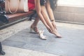 Business woman sitting on the street chair and push her leg take a rest