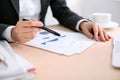 Business woman sitting at the table and examines the financial results Royalty Free Stock Photo