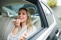 Business woman with smartphone and laptop sitting on back seats in taxi car. Royalty Free Stock Photo