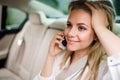 Business woman with smartphone sitting on back seats in taxi car. Royalty Free Stock Photo