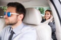Business woman with smartphone sitting on back seats in taxi car, talking. Royalty Free Stock Photo