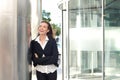 Business woman smiling with arms crossed outside office building Royalty Free Stock Photo