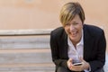 Business woman smiling with a mobile phone on hand Royalty Free Stock Photo