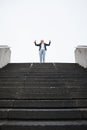 Business woman, stairs and celebration for success, goal or winning in finance career, investment or stock market. Young Royalty Free Stock Photo