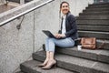 Business woman, stairs and thinking with laptop, planning schedule and ideas, copywriting and typing in city. Young Royalty Free Stock Photo