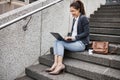 Business woman, stairs and typing on laptop, planning schedule and thinking with ideas, copywriting or city. Young Royalty Free Stock Photo