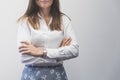 Business woman standing with arms crossed, front view