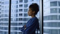 Businesswoman with crossed hands standing in office.Portrait of thoughtful lady Royalty Free Stock Photo