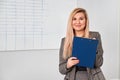 Business woman standing with clipping board in the office and ready to write something. Royalty Free Stock Photo