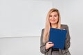 Woman standing in the office and ready to write something. Royalty Free Stock Photo