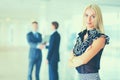 Business woman standing in foreground in office