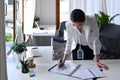 Businesswoman standing at her offie desk and checking financial reports. Royalty Free Stock Photo