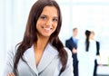 Business woman standing with her staff in background at office Royalty Free Stock Photo