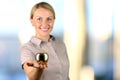 Business woman standing and holding golden apple in her hand. Royalty Free Stock Photo