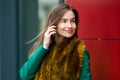 Business woman standing by modern office building, smiling and talking on the phone Royalty Free Stock Photo