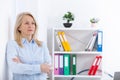 Business woman standing near the wall looking out the window thinking over the strategy. Royalty Free Stock Photo