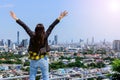 Business woman standing On the rooftop and raising arms when she made the assignment to success. According to the target. or Royalty Free Stock Photo