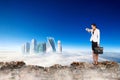 Business woman stands on the edge of mountain and looking on city. Royalty Free Stock Photo