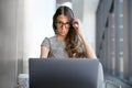 Business woman staring at computer screen, suffering vision loss and bad eyesight, needs prescription glasses Royalty Free Stock Photo