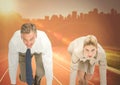 Business woman at start line against orange flare and skyline Royalty Free Stock Photo