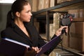 Business woman stock counting in warehouse