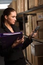 Business woman stock counting in warehouse Royalty Free Stock Photo