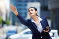 Business woman stop to call uber, taxi or cab in road for travel, transport and commute to work destination. Young Royalty Free Stock Photo