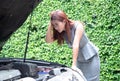 Business woman with stress look into the hood to see the car broke down Royalty Free Stock Photo