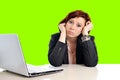 Business woman in stress at work with computer pulling her red hair isolated on green screen chroma croma Royalty Free Stock Photo