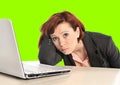 Business woman in stress at work with computer pulling her red hair isolated on green screen chroma croma Royalty Free Stock Photo