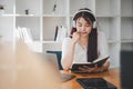 Business woman student teacher tutor wear wireless headset video conference calling on laptop computer talk Royalty Free Stock Photo