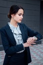 business woman in suit looks at watch Royalty Free Stock Photo