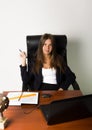 Business woman in a suit sitting at a desk